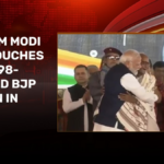 video: pm modi hugs, touches feet of 98 year old bjp veteran